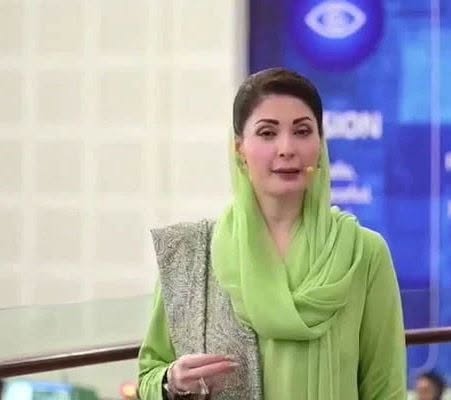 May be an image of one or more people, television, scarf and newsroom