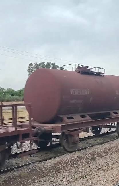May be an image of train, railroad and text